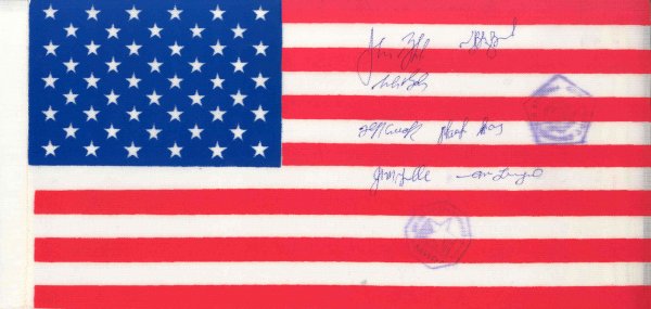 US Flag FLOWN on STS 81 & Autographed: A flown nylon flag (9.5 x 4.5"") signed by the full crew of STS-81. The flag bears STS-81 and MIR onboard cancels. Signed in blue ink. Very good condition.