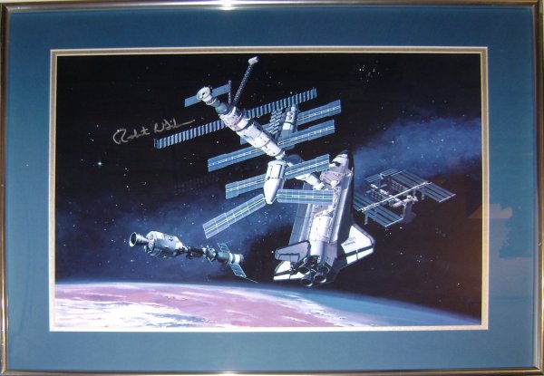 Robert Gibson Autograph on MIR Concept Artwork: Color artwork (16 x 22") of Mir Space Station mounted in a blue mat and silver metal frame, glass not included. Autographed in silver Sharpie by astronaut Robert Gibson. Very good condition.