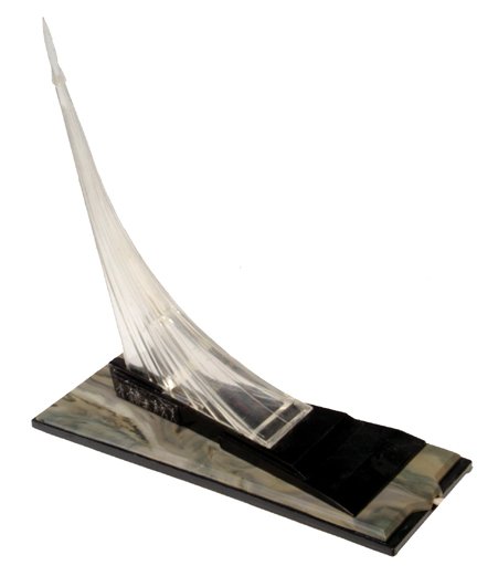 Russian Baikanur Rocket Table Lamp: (6 x 7") a clear lucite lamp that depicts the Baikonur Monument. There is a clear lucite rocket at the apex of the column of fire. The lamp is mounted on a flat (7 x 3") plastic base. There is a heroi