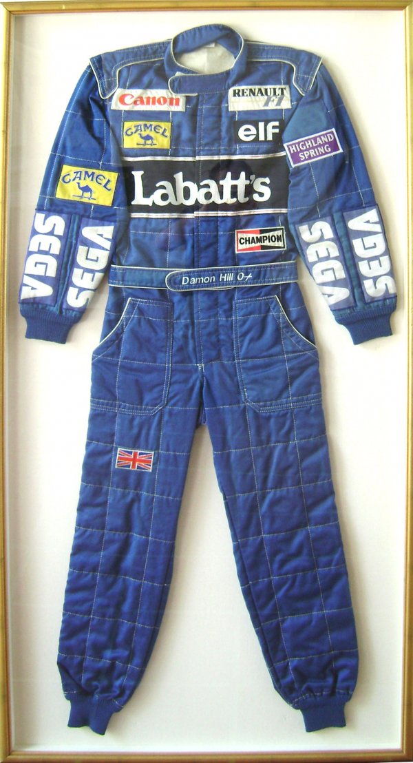 Damon Hill Renault Racing Suit: Dark blue Camel/Renault racing suit. Emblazoned with sponsors: Labatt's Champion, Camel, Canon, Renault, Elf, Highland Spring and Sega. On the waistband is stitched "Damon Hill Ox", and on the right k
