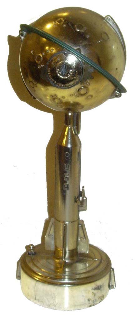 USA Moon Rocket Bank Mercury Commemorative: (10 x 3.50") Inscribed "Shepard, Grissom, Glenn, Carpenter, Schirra, Cooper Commemorating LT. COL. John H. Glenn Jr's triumphant triple orbit of the Earth February 20, 1962. Model 1000 Destination - M