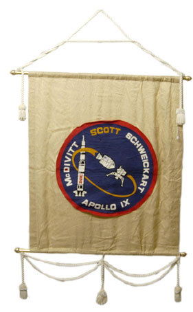 Dave Scott Autograph on an Apollo 9 Patch Banner: Dave Scott Autograph on an Apollo 9 Patch Banner A large display banner (34x40") bearing a felt rendition (24") of the Apollo 9 mission patch, which David Scott has signed. Some faults but attractive