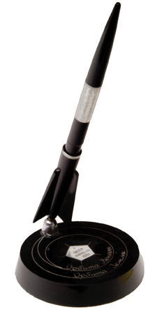 1961, "Venusian Fountain Pen and Pen Holder A str: 1961, "Venusian Fountain Pen and Pen Holder A striking black plastic fountain pen mounted in a "rocket" shaped holder with a 3.5" round plastic base. There is a silver band on the pen and a silver pen