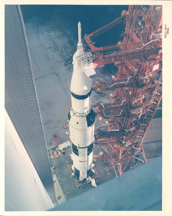 Apollo 12 NASA Red #'d Photograph: ASA red #"d color photograph (S-69-51308) on Kodak paper (8 x 10") view at launch complex 39 showing the Apollo 12 space vehicle leaving the Vehicle Assembly Building on the way to pad A. Excellent co