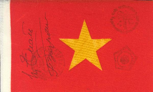 Soyuz 37 FLOWN Vietnamese Flag Crew Autographed: "A flown nylon flag (7 x 4.5"") signed by the full crew of Soyuz-37. The flag bears Soyuz-37 and Salyut-6 onboard cancels. Signed in black ink. Very good condition.