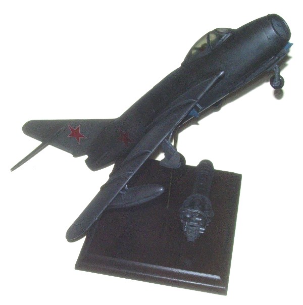 Soviet MIG-15 BIS Fighter Model: (13.75 x 11.75") Mig-15 BIS Fighter Model also includes a (5.75 x 1.50") Jet engine on an (8 x 6 x .75") wooden base. The MiG-15, built by the Soviet Union, was one of the first successful swept-wing 
