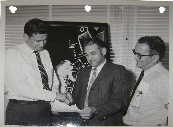 Aerospace Corporation Citation Presented to Grubb: Presented to James Grubb; also included a (8 x 10") black and white photograph of the certificate presentation. Good condition with toning.