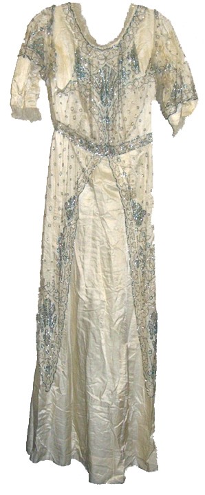 Stunning Womans Edwardian Ivory Silk Gown: Womans Edwardian Ivory Silk gown embellished with an net overdress heavily beaded with turquoise and silver beads. A classic example of the Titanic era evening gown. Very good condition with some unde
