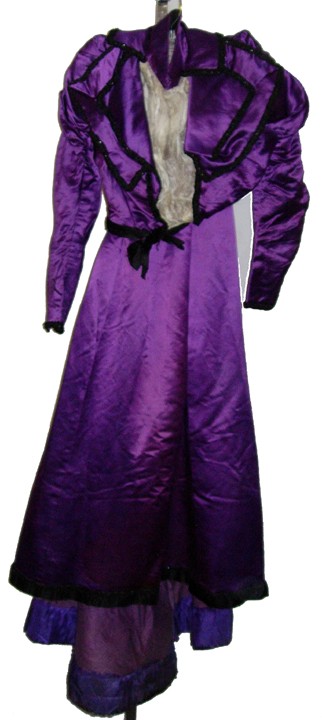 Womens 1890's Edwardian Evening Gown.: An elaborate 1890's royal purple satin evening gown. The bodice has wide lapels that are lavishly decorated with black jet beading. It has a high neck collar and a white chiffon front insert. The wais