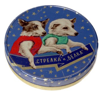 Lithographed Multicolor Tin Container: (6x1") A multicolor round tin container picturing space dogs "Belka and Strelka" surrounded by stars. Minor rubs, but in excellent condition given its 40+ years of age. Attractive.