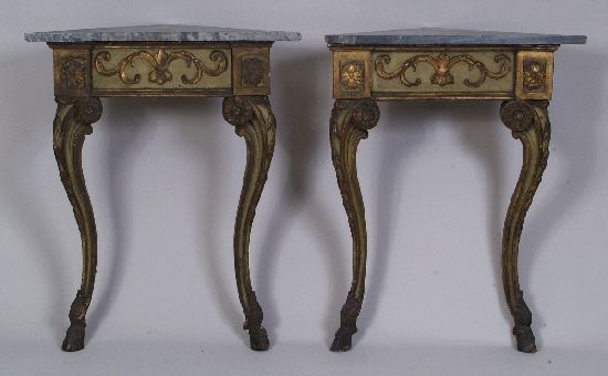 A pair of green painted and gilded corner console: A pair of green painted and gilded corner console tables, late 18th century, possibly Italian, each with stylised floral squares, scroll motifs, raised on cabriole legs with husk drops and hoof feet,