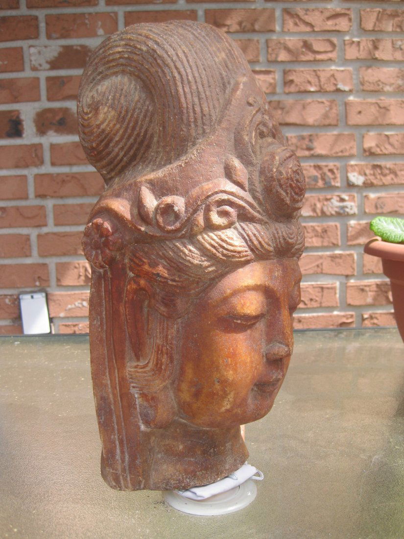 Carved Chinese/Tibetan stone head of Guan Yin, 35 lb: Carved stone head of Guan Yin, 35 lb. =16 kg, 14 in.=35cm. Material: carved stone, -marble(?) with original reddish paint. At the base of the statue, one could see crystals, shining on the sun. Origin