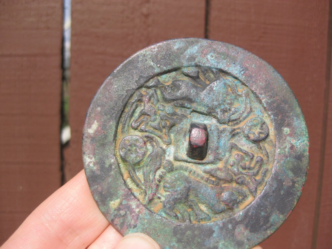 Six Dynasties, Chinese bronze mirror, 2 chasing animals: Six Dynasties (265-589), Chinese bronze mirror, 2 chasing animals. 100% authentic and very pleasant. Period: Six Dynasties 265-589 AD; Diameter: 3â€ inches = 76 mm; Weight: 4 oz. = 123 g; Rim: flat