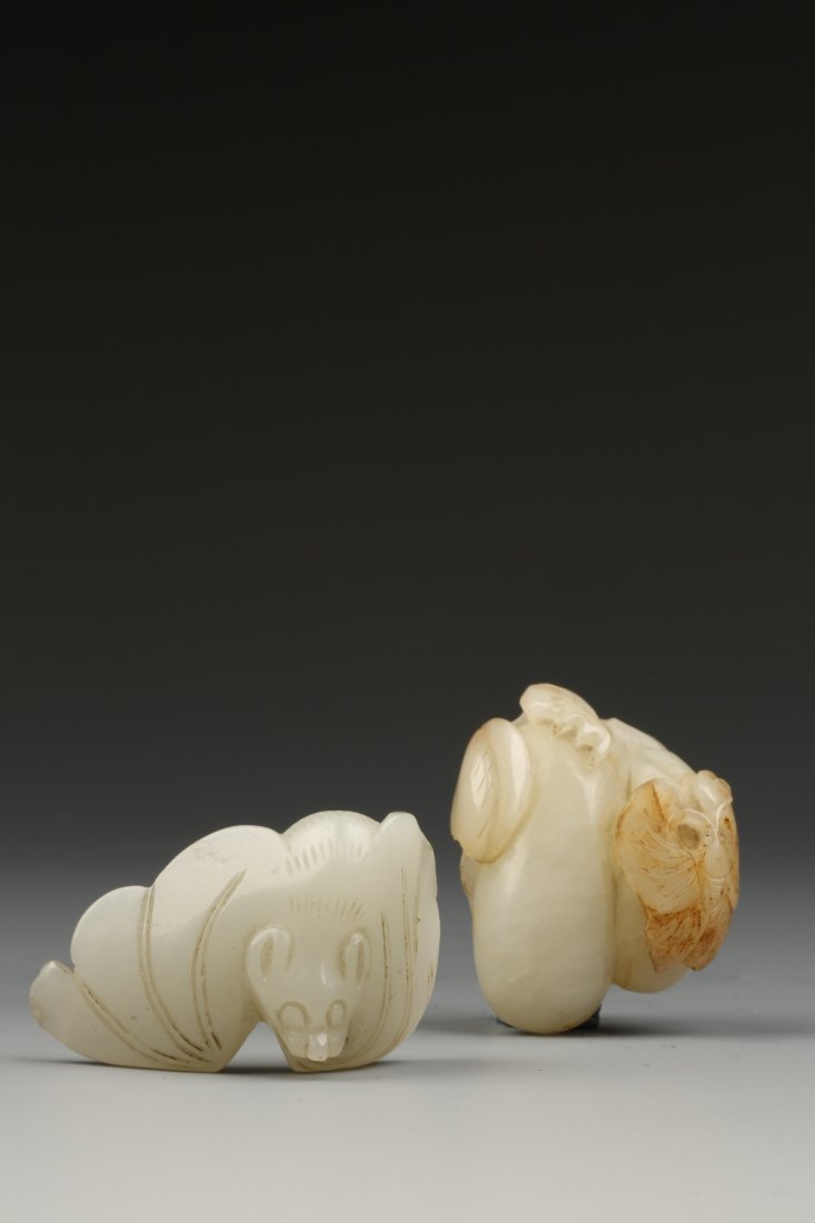 A PALE CELADON AND RUSSET JADE CARVING of two gourds wi: A PALE CELADON AND RUSSET JADE CARVING of two gourds with a butterfly, Qing, 1.5" long; and a celadon jade carving of a bat, 1.5" long Provenance: The Anthony Bate Collection of Chinese Snuff Bottles 