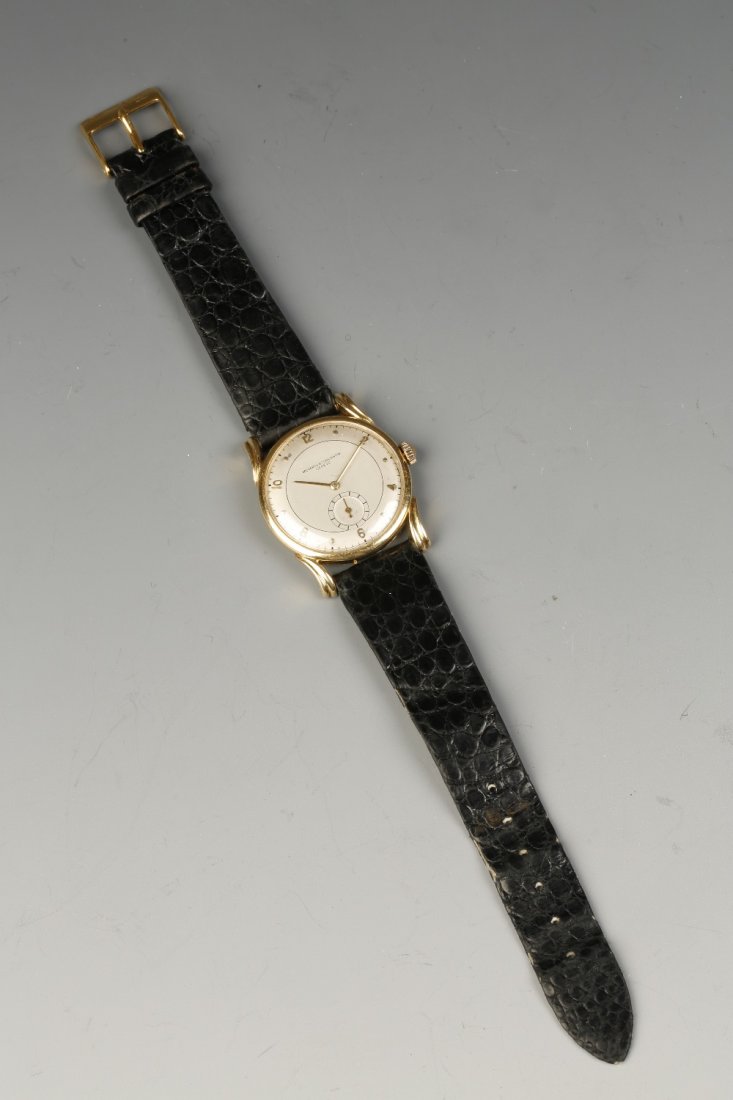 VACHERON & CONSTANTIN: A GENTLEMAN'S 18CT YELLOW GOLD M: VACHERON & CONSTANTIN: A GENTLEMAN'S 18CT YELLOW GOLD MECHANICAL WRISTWATCH, the round dial with Arabic and dot numerals, with subsidiary seconds dial, the scrolled lugs attached to a black leather st