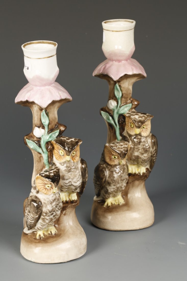 A PAIR OF 19TH CENTURY STAFFORDSHIRE PORCELAIN CANDLEST: A PAIR OF 19TH CENTURY STAFFORDSHIRE PORCELAIN CANDLESTICKS, each modelled in the form of a pair of owls perching on a tree trunk, the white glazed candle sconce with gilt banding, each with an inscri