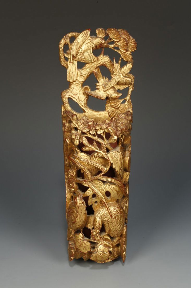 A CHINESE GILT-WOOD WALL POCKET, the top with birds in : A CHINESE GILT-WOOD WALL POCKET, the top with birds in flight beside prunus, the lower area with quail amongst foliage, late Qing/Republic, 11.5" high¦