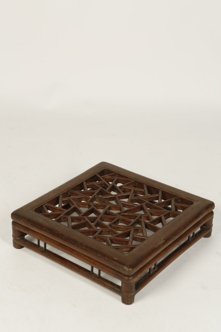 A CHINESE HARDWOOD FOOT REST, of square form with a pie: A CHINESE HARDWOOD FOOT REST, of square form with a pierced 'cracked-ice' top, Qing, 20" x 20"