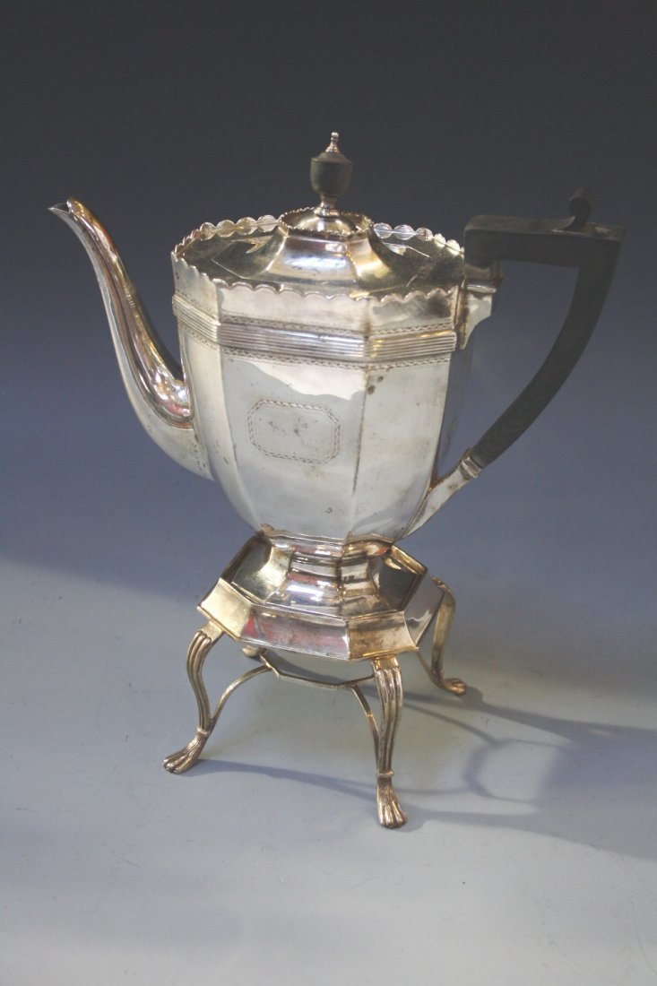 A VICTORIAN TEAPOT ON STAND of octagonal form with an: A VICTORIAN TEAPOT ON STAND of octagonal form with an angular handle, reeded border, on a stand with fluted down curving legs, by Charles Stuart Harris, London 1894, 12" high (c.30oz)