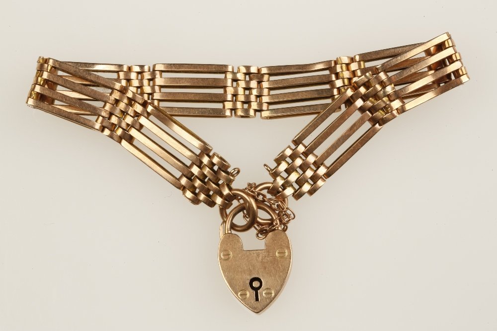 A 9CT ROSE GOLD GATELINK BRACELET with heart padlock: A 9CT ROSE GOLD GATELINK BRACELET with heart padlock clasp and safety chain, (c.19grams)