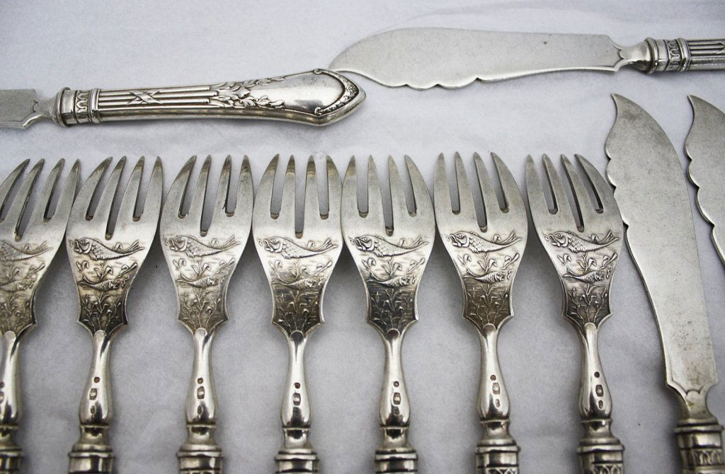 24pc. Polish Solid 830 Silver Fish Fork Knife Set: Vintage 24 piece solid 830 all silver fish eaters set, made in Poland c. 1920. The pieces are ornately chased with swimming fish. The forks are in a classic design with matching knives that are emboss