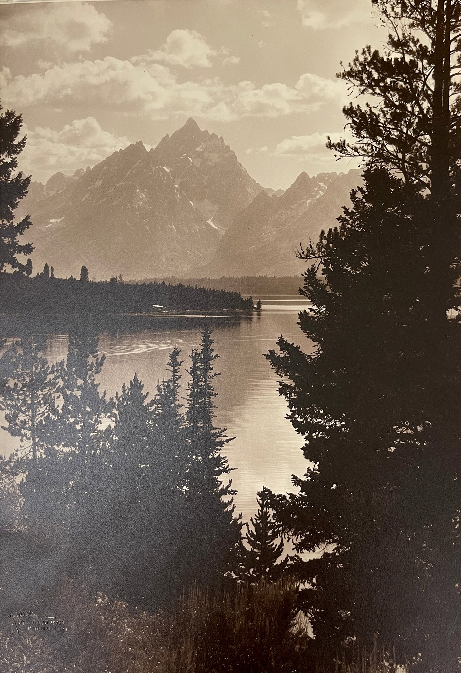 Harrison Crandall | The Grand Teton Evening light on Jackson lake: Harrison Crandall | The Grand Teton Evening light on Jackson lake Photograph, on the lower left stamped, on the back titled and numbered 1081 size 20" x 14", framed 25.5" x 32" Provenance: Private col