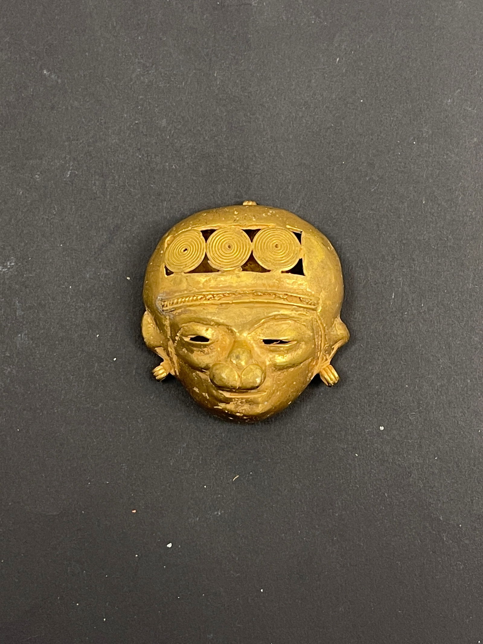 Ancient Pre-Columbian Mixed Metal Pendant Central or South America, circa 500–1200 CE: A rare and finely crafted Pre-Columbian pendant, made from a mixed-metal alloy, possibly a combination of copper, gold (tumbaga), or bronze, characteristic of early metallurgical traditions in ancient