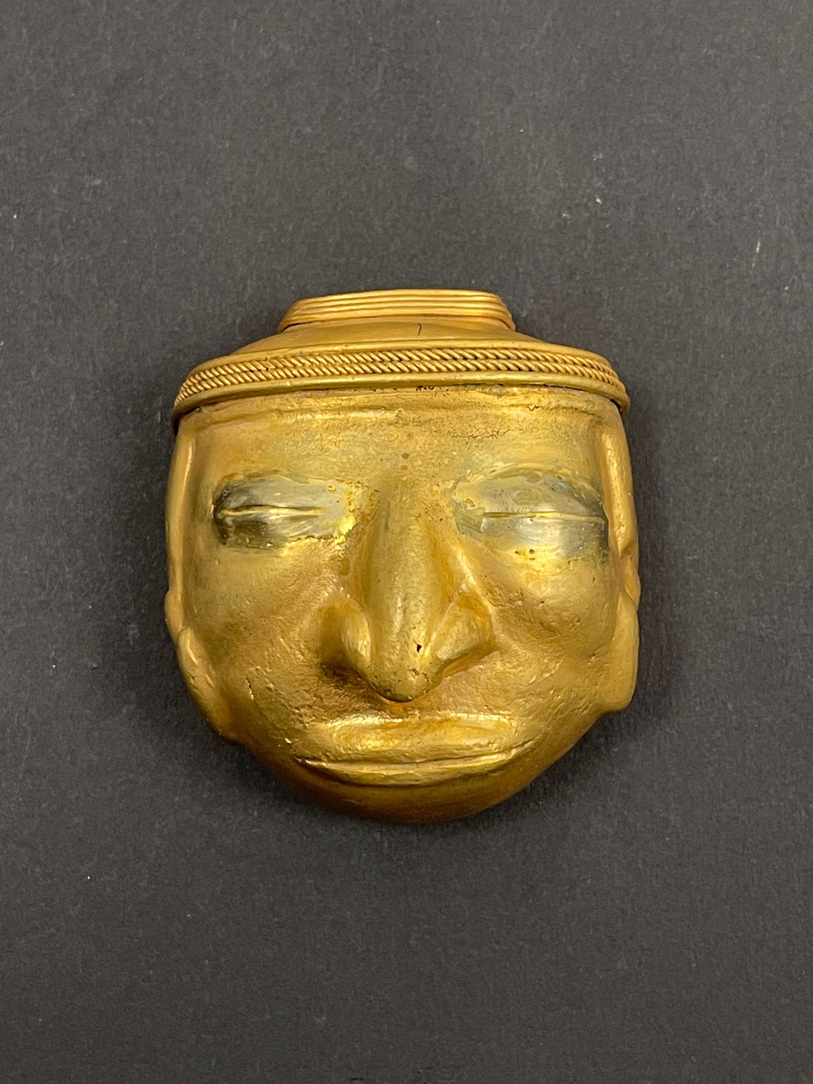 Ancient Pre-Columbian Mixed Metal Pendant Central or South America, circa 500–1200 CE: A rare and finely crafted Pre-Columbian pendant, made from a mixed-metal alloy, possibly a combination of copper, gold (tumbaga), or bronze, characteristic of early metallurgical traditions in ancient