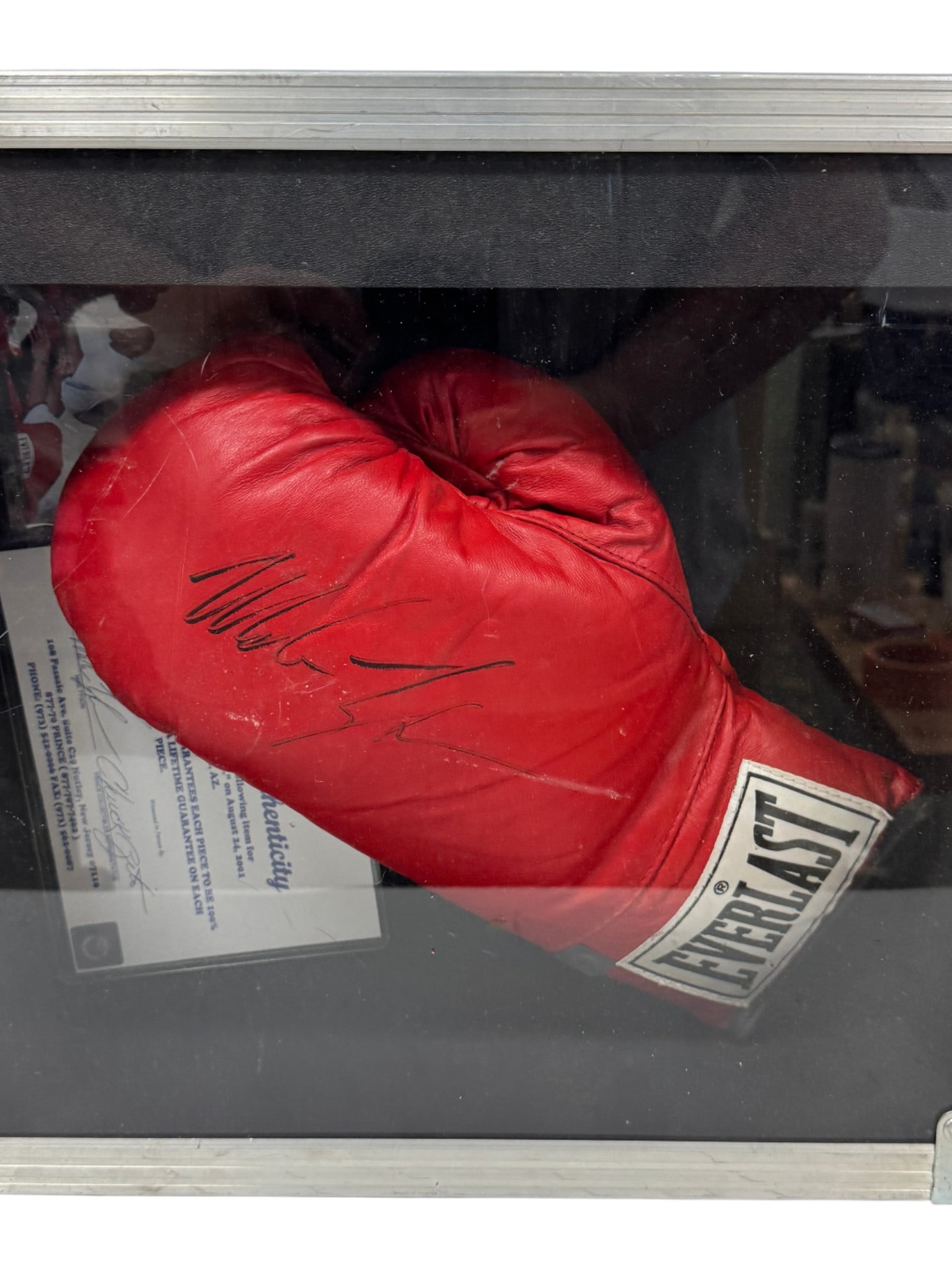 Mike Tyson Signed Everlast Boxing Glove with COA: Red Everlast boxing glove autographed by Mike Tyson, displayed in case with COA.