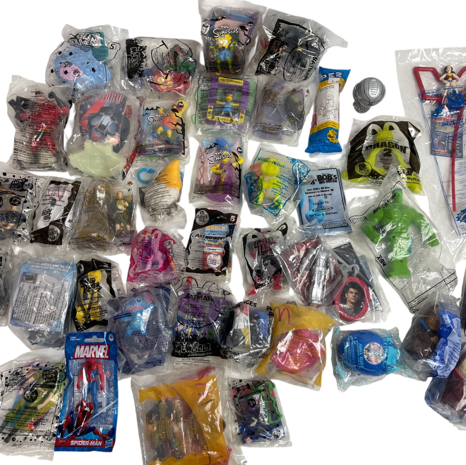 McDonald's Toy Collection Lot: Large assortment of sealed McDonald's toys including Simpsons, Batman, and Marvel. Great collectible mix.