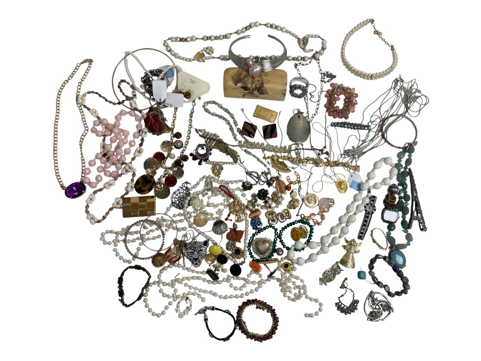 Assorted Vintage Necklaces and Costume Jewelry: Collection of costume jewelry featuring necklaces, pendants, earrings, and bracelets. Includes colorful beaded strands, enamel and metalwork, and statement pieces.