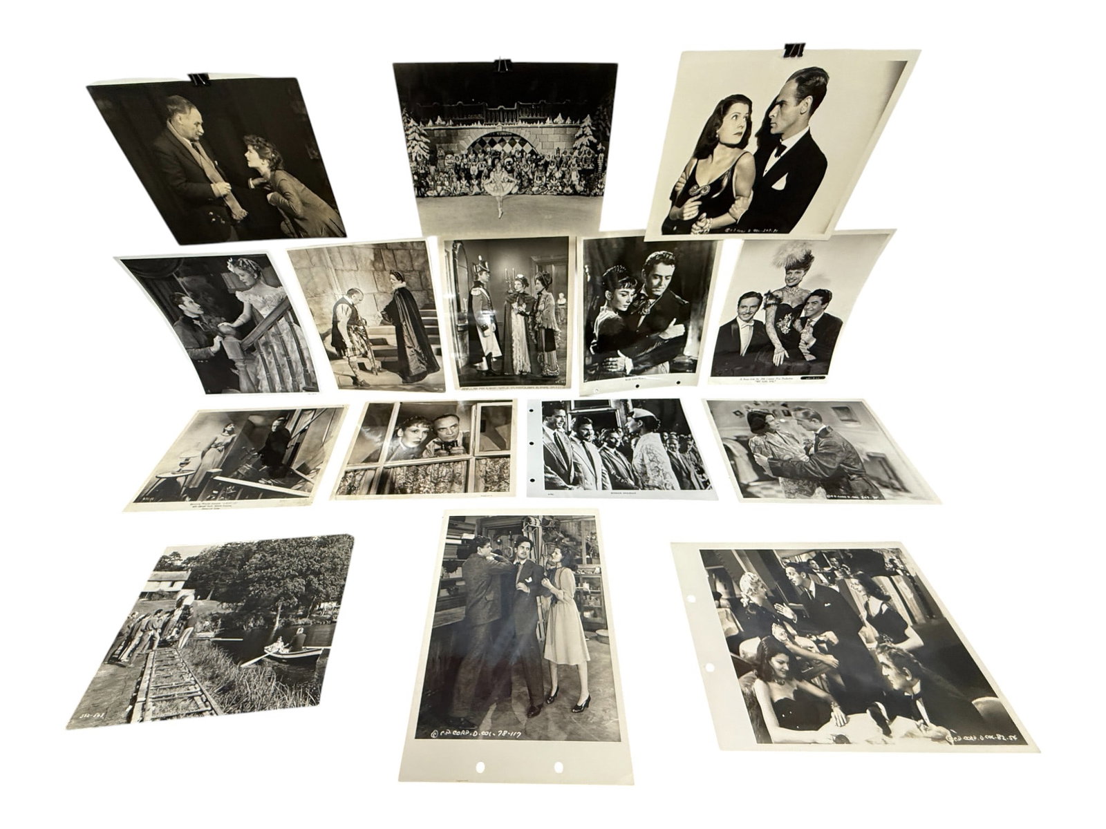 Collection of Vintage Film Stills and Publicity Photos (Approx. 15): Lot of black and white studio stills depicting actors and directors from 1940s–1950s motion pictures. Crisp photographic prints with vintage annotations to reverse.