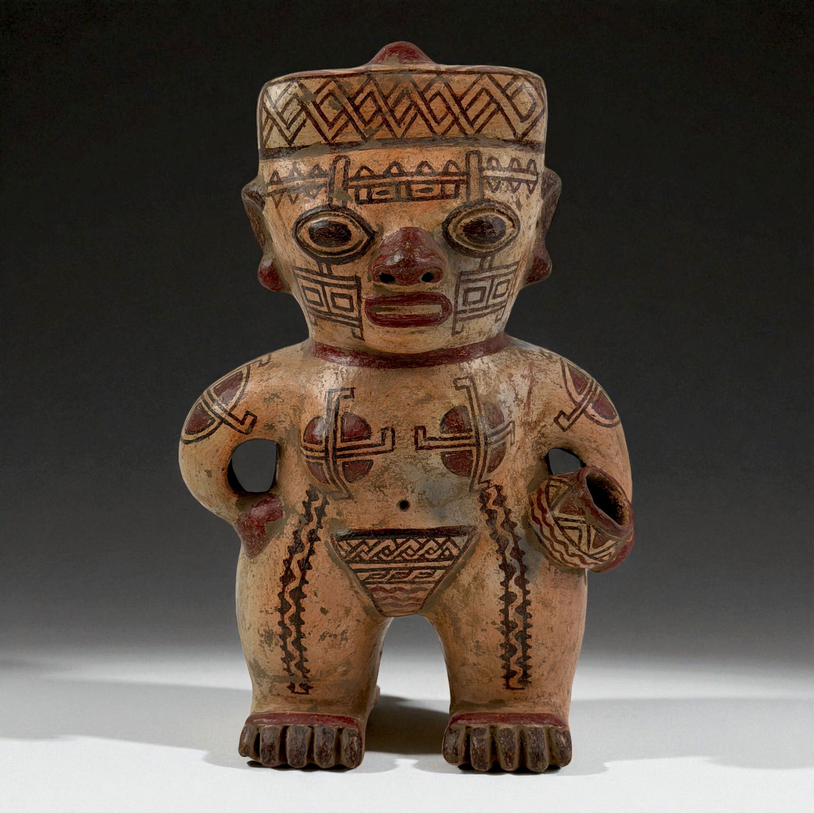 Pre-Columbian Tribal Painted Figure: Ceramic figure with bold facial paint, geometric body markings, and a strong upright pose. The incised and painted motifs reflect ceremonial artistry typical of indigenous regional craftsmanship. A de