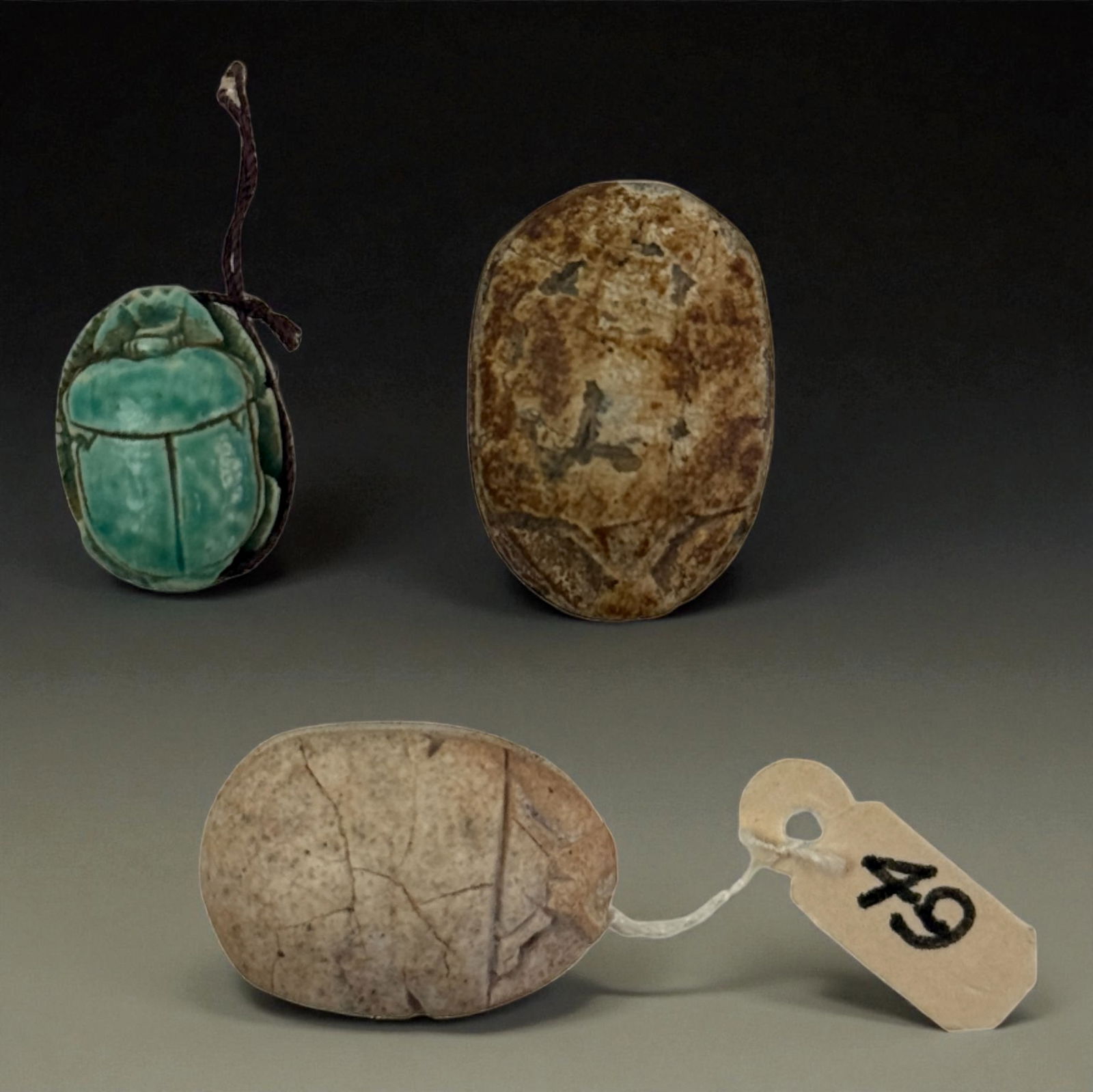 Group of Ancient Scarab Carvings: Set of carved scarabs including faience and stone examples, each with distinct patina, symbolic form, and burial wear. Fine collection of ancient amulets. Provenance: Beverly Hills Barakat Gallery Col
