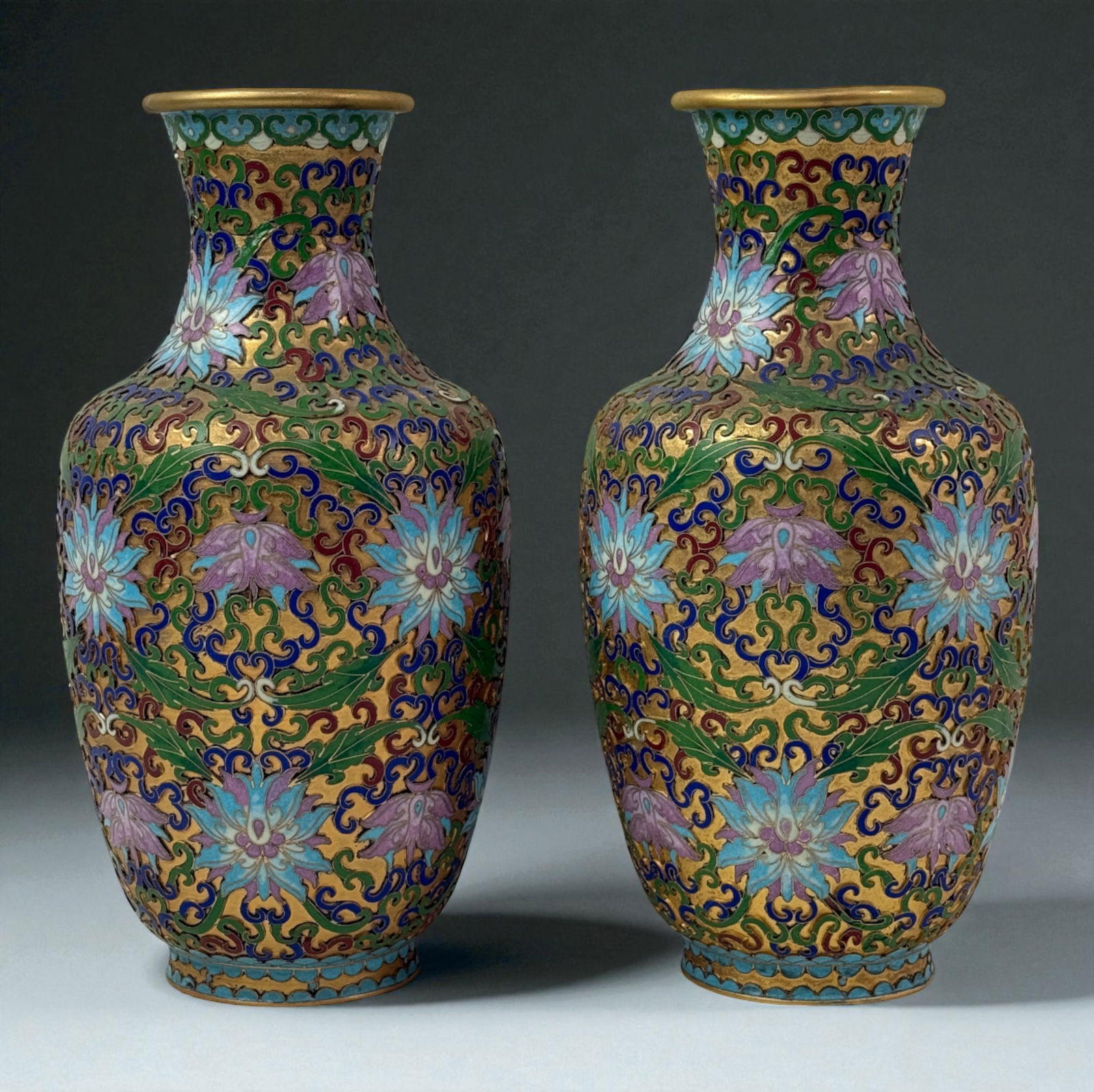 Pair of Chinese Cloisonne Vases Gold Floral Scrolls: Pair of Chinese cloisonne vases with gilt floral scrollwork, blue and green foliage, and purple blossoms on gold ground; fine hand-enameled pair. 12"