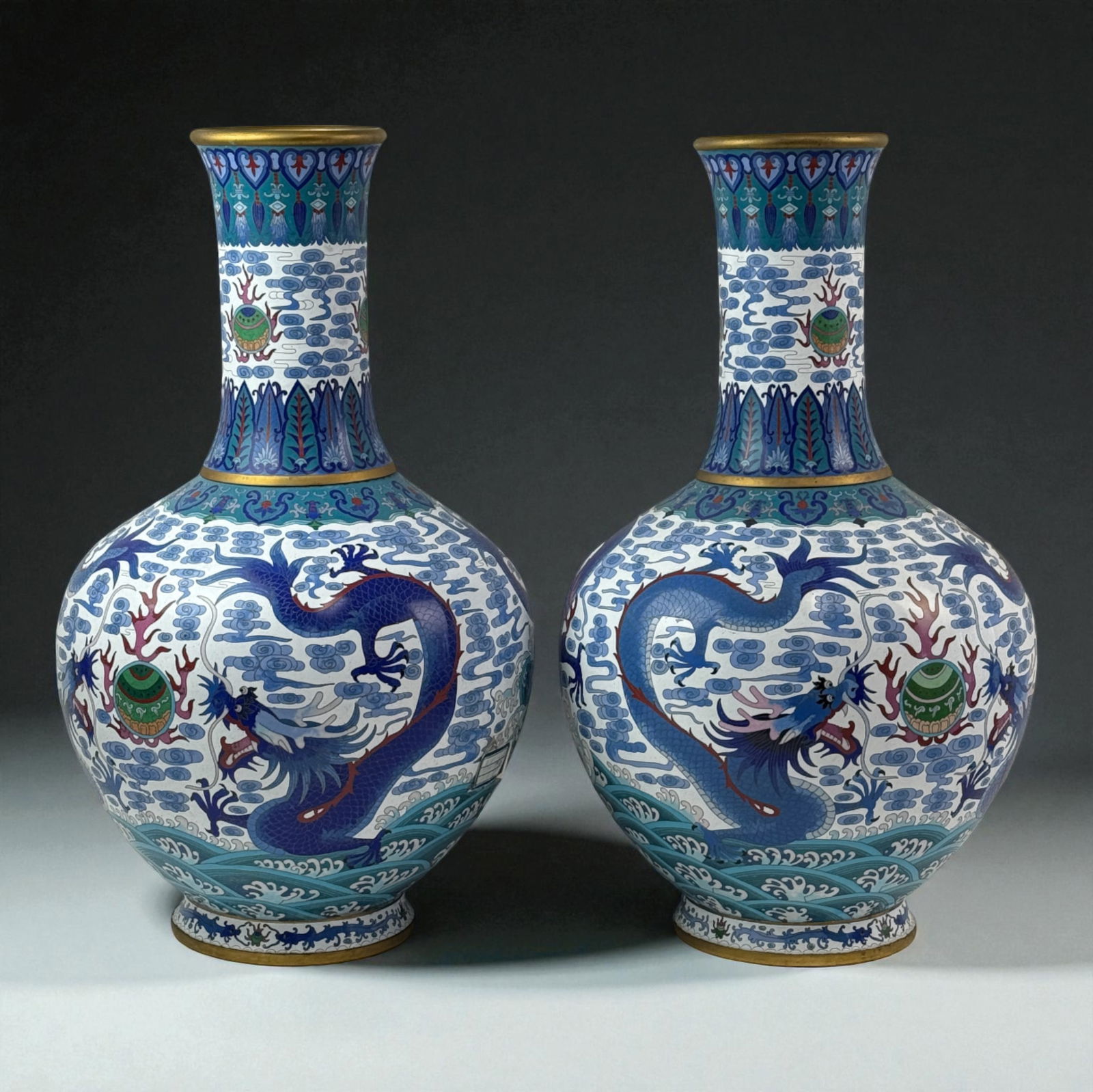 Pair of Chinese Cloisonne Vases Gold Floral Scrolls: Pair of Chinese cloisonne vases with gilt floral scrollwork, blue and green foliage, and purple blossoms on gold ground; fine hand-enameled pair. 26"