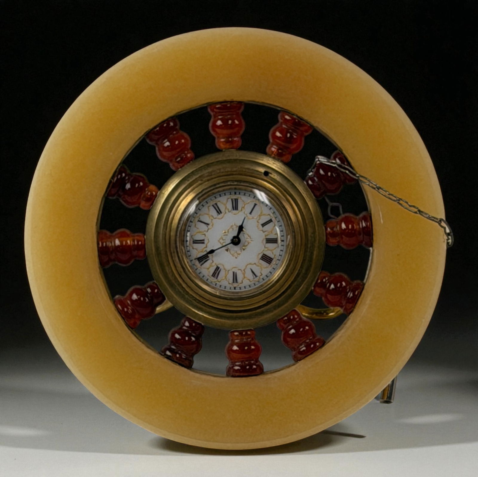 Antique European Stone & Brass Clock Wheel: Antique clock set in amber-like stone circular frame with brass center and red bead spokes.Provenance: Beverly Hills Barakat Gallery Collection.