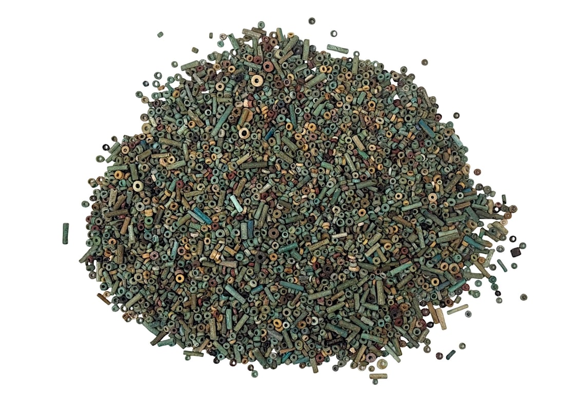 Ancient Egyptian Faience Mummy Loose Beads for JewelryBeads 1 Pound: Ancient Egyptian Faience Mummy Loose Beads for JewelryBeads 1 Pound stone and faience beads of various forms and sizes, likely used for necklaces or ritual adornments. Provenance: Beverly Hills Baraka