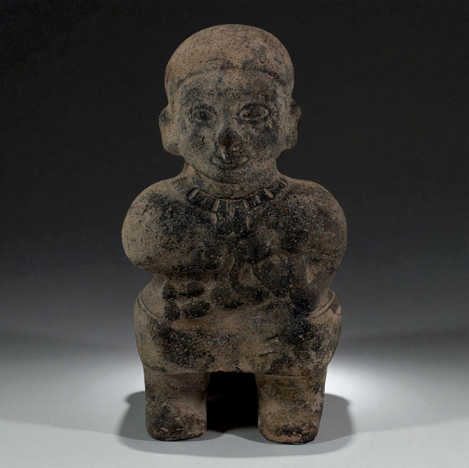 Pre-Columbian Carved Stone Female Figure: Heavily weathered carved stone figure with rounded body and faint incised facial features. Provenance: Beverly Hills Barakat Gallery Collection.