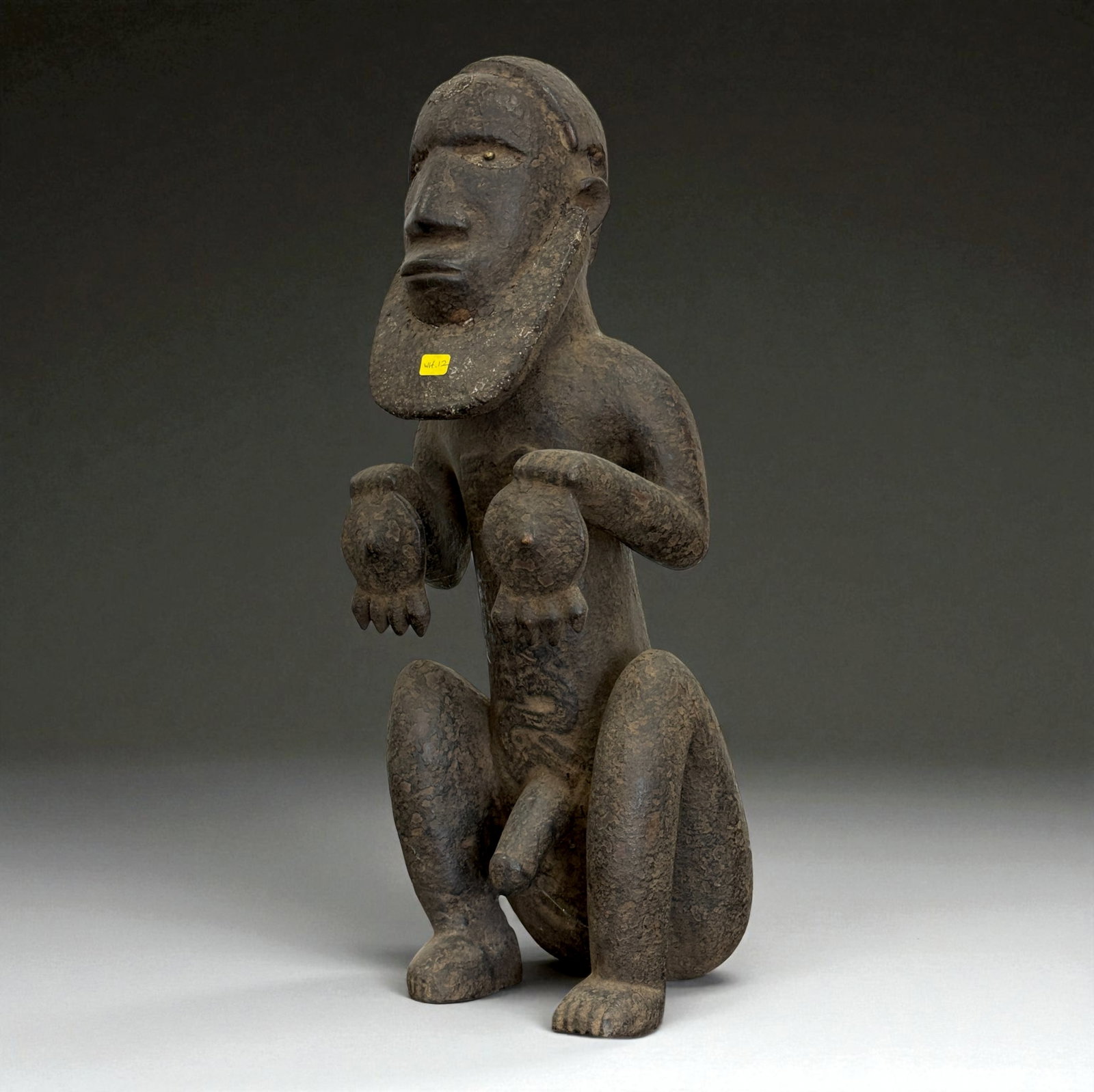 African Carved Male Figure: Large wooden kneeling male figure with long beard and pronounced anatomical details, carved in expressive traditional manner. 19th?20th Century. Provenance: Beverly Hills Barakat Gallery Collection. 2