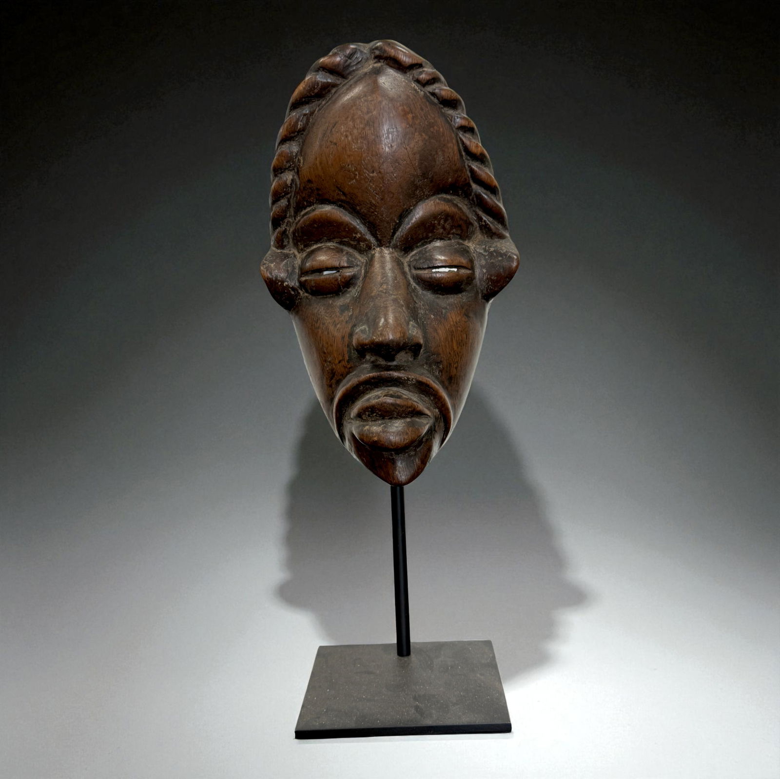 African Carved Mask: African carved wooden figure or mask displaying traditional regional craftsmanship, likely 19th?20th Century. Provenance: Beverly Hills Barakat Gallery Collection. 10" inches