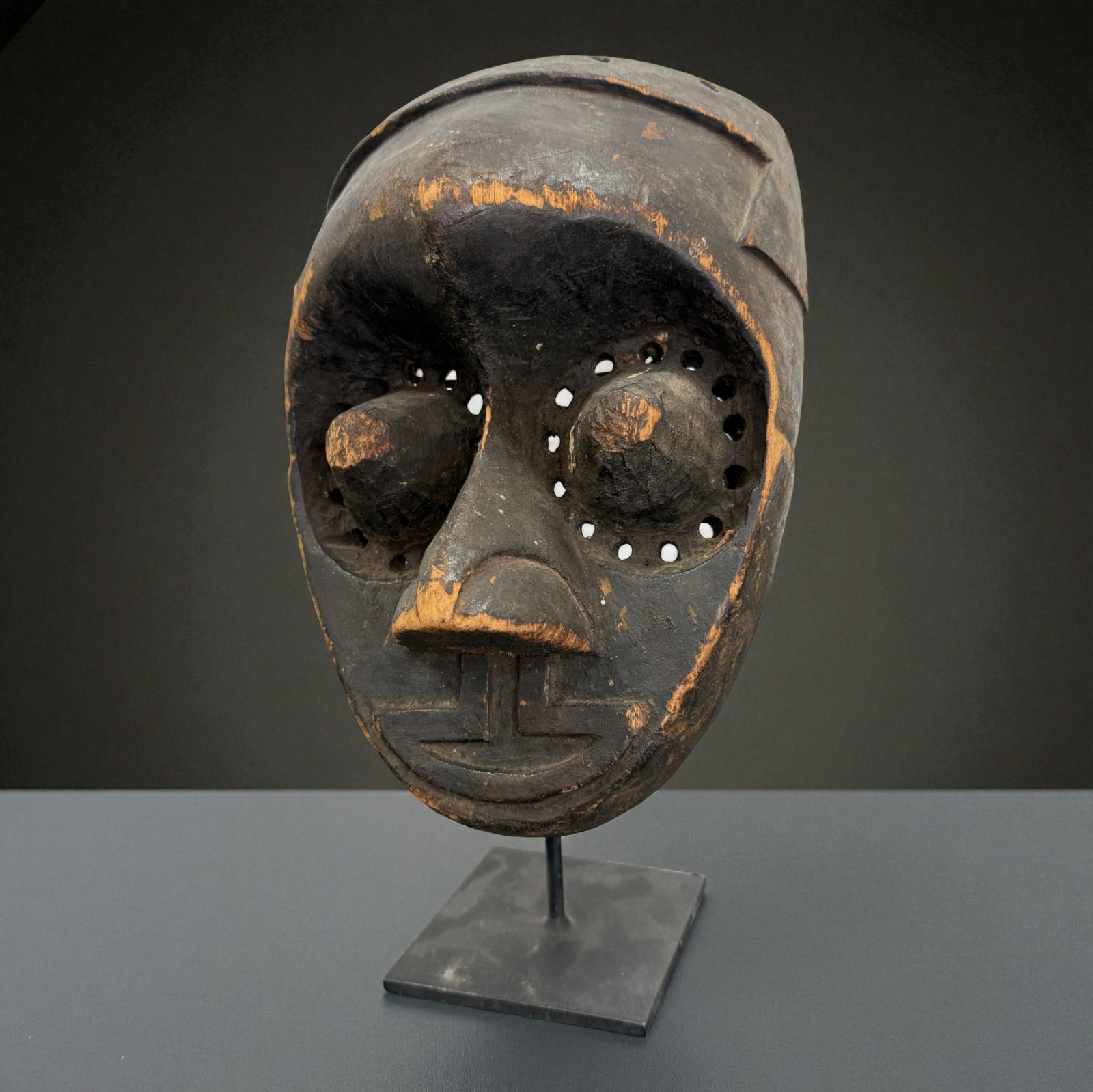African Carved Mask with Pierced Eyes: Carved Mask with Pierced Eyes, hand-carved traditional African tribal art. Provenance: Beverly Hills Barakat Gallery Collection. 11"
