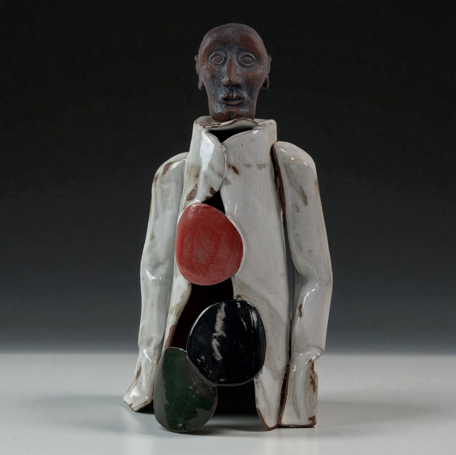 African Ceramic Figure: African ceramic figure with multicolored sculptural elements.Provenance: Beverly Hills Barakat Gallery Collection. 14"