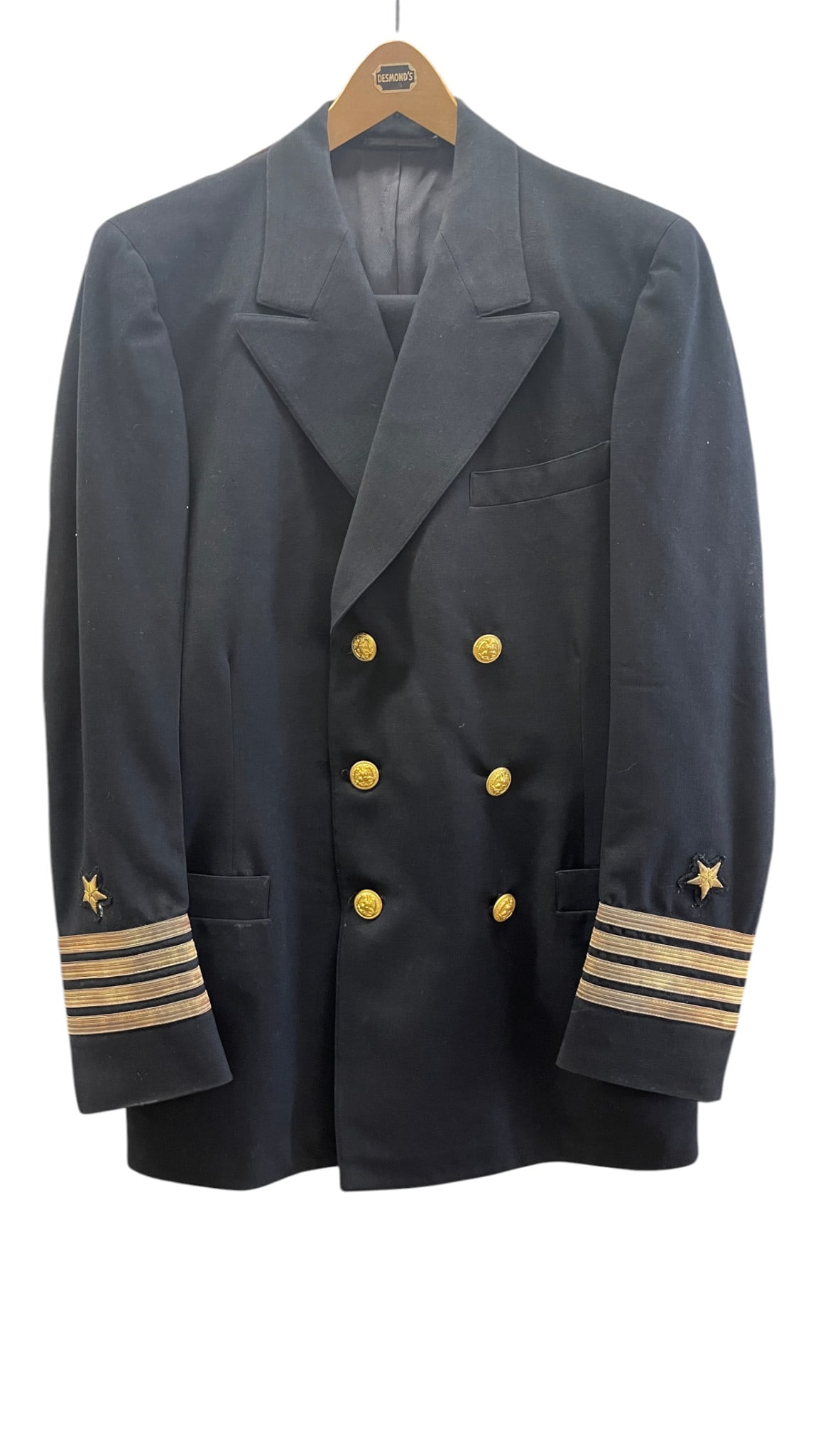 U.S. Naval Officer Dress Blue Uniform Jacket: Classic dark navy double-breasted officer’s dress jacket with gold buttons, cuff rank striping, and star insignia, presented without medal bar. A clean and attractive military uniform example