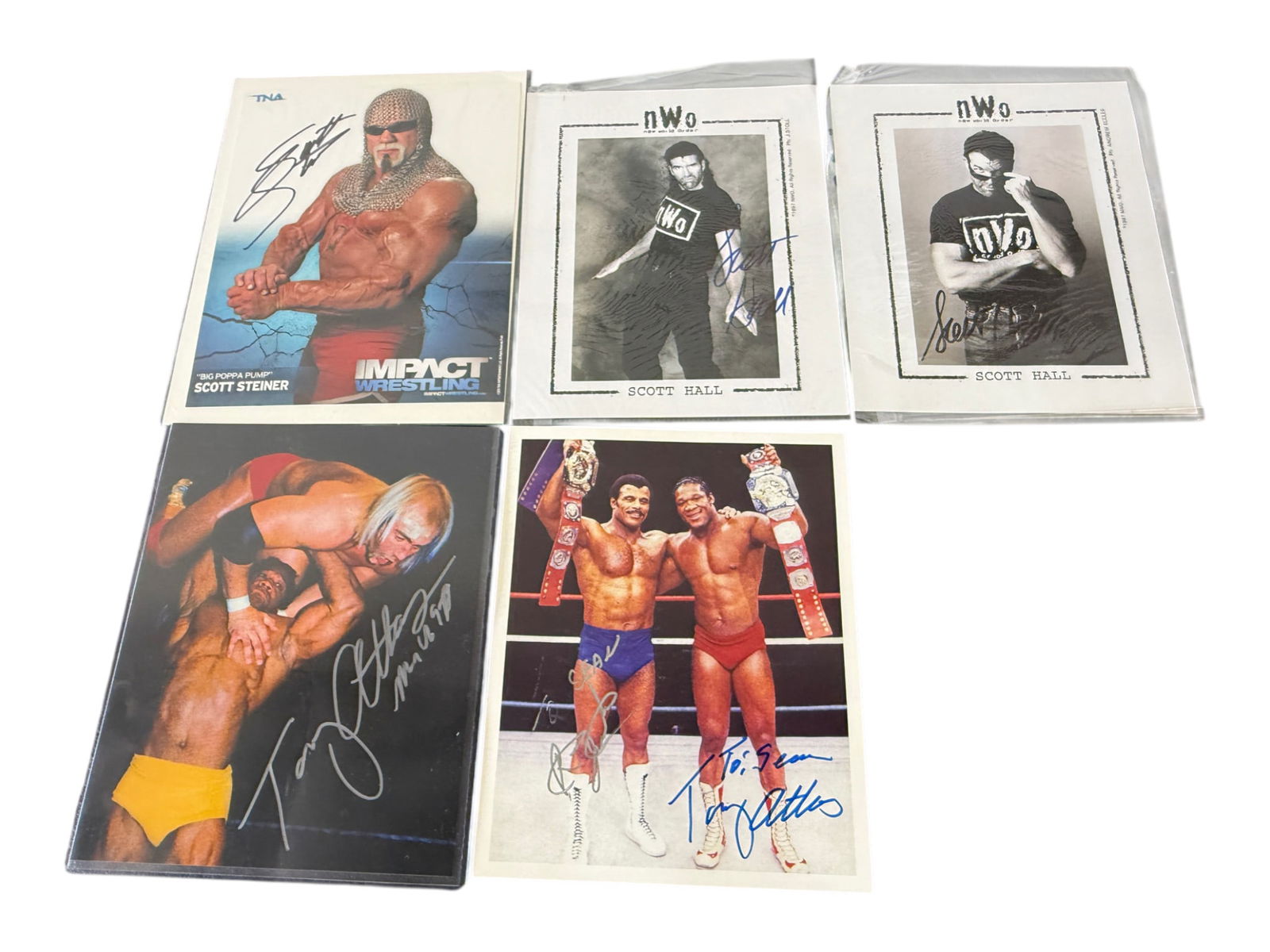 Group of Five Signed Professional Wrestling Photos: Group of five signed professional wrestling photographs and promo images, including Scott Steiner and Scott Hall examples, together with additional signed ring-action and tag-team wrestling photos. A