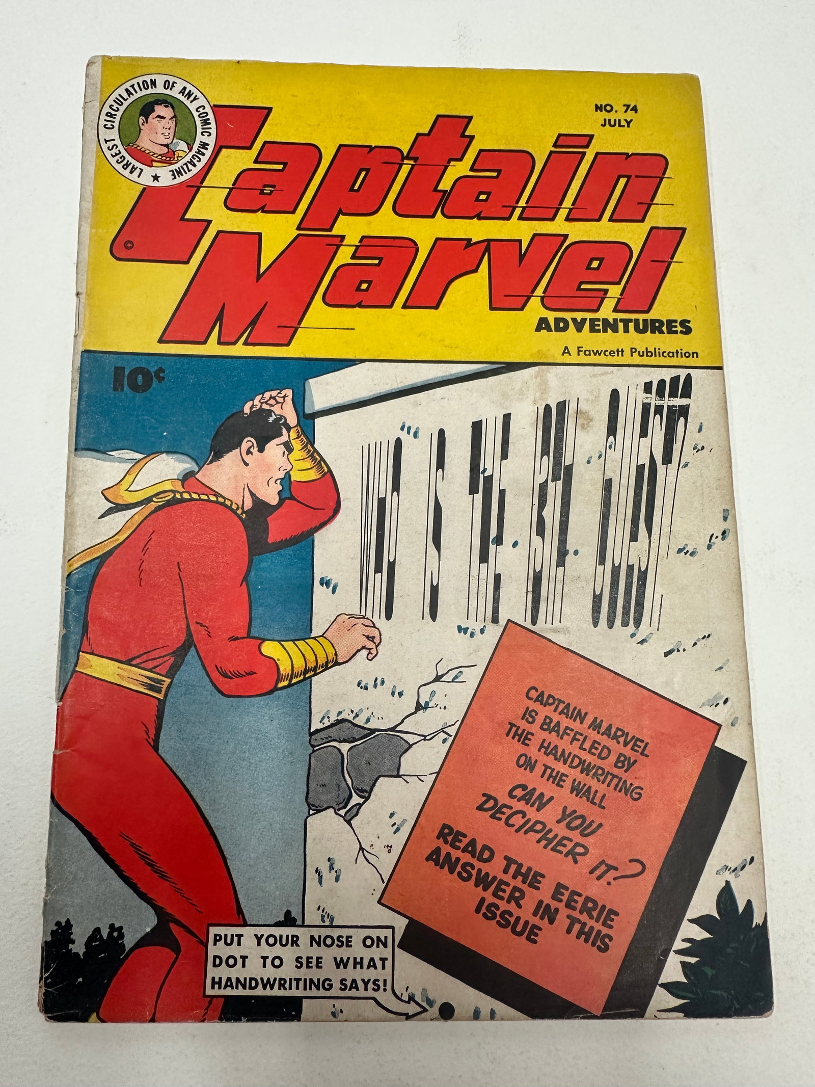 Captain Marvel Adventures #74, Fawcett Publications, July 1947: Captain Marvel Adventures No. 74, published by Fawcett Publications, dated July 1947, priced at 10 cents. This Golden Age comic features a memorable interactive cover with a 'handwriting on the wall' 