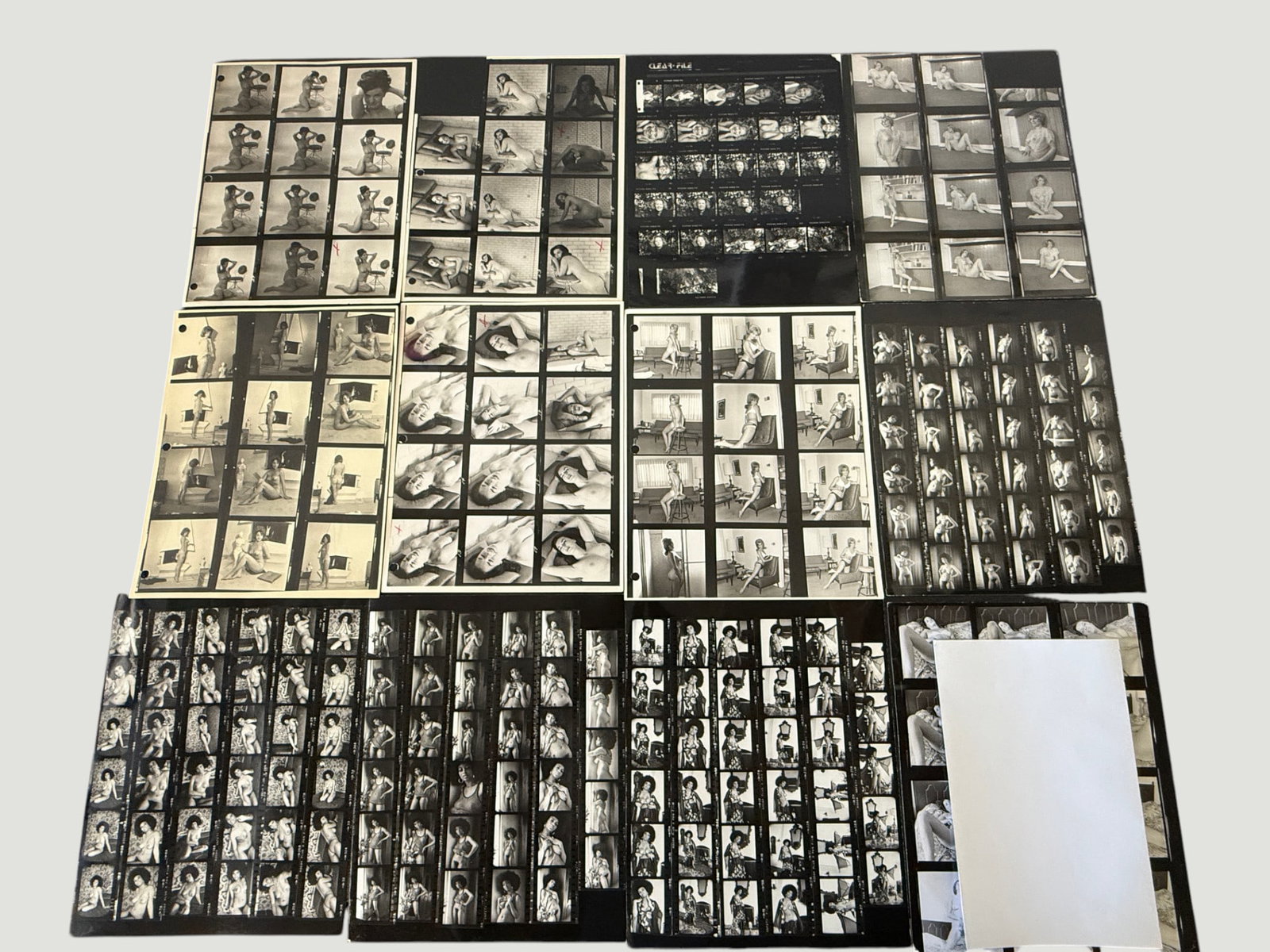 Vintage B&W Photography Contact Sheets, Nude & Figure Studies, c.1970s: A collection of approximately 12 black and white photographic contact sheets from what appears to be the 1970s era, featuring professional figure and nude study photography sessions. The sheets includ