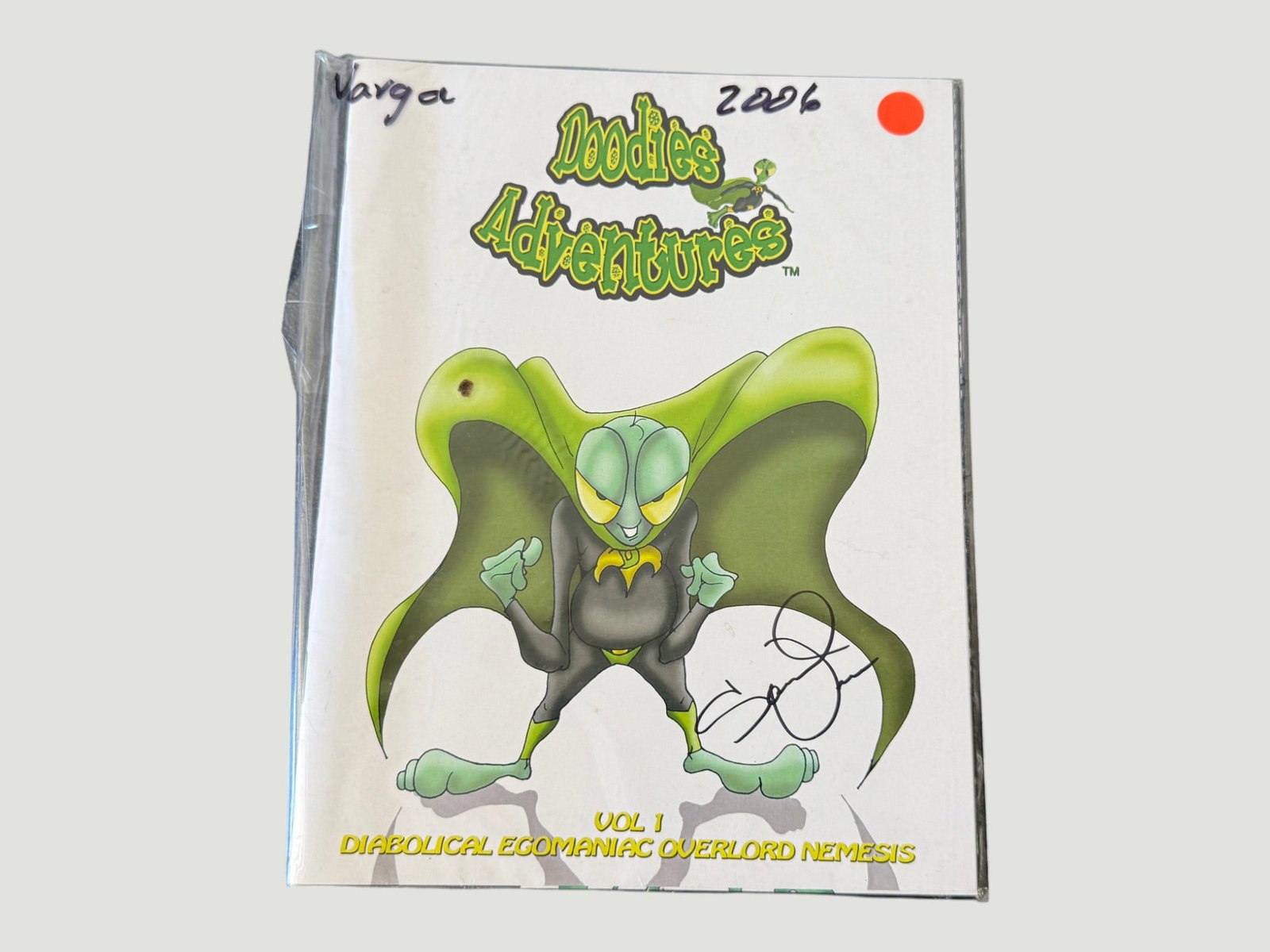Doodie's Adventures Vol. 1 'Diabolical Egomaniac Overlord Nemesis' Signed 2006: A bagged copy of 'Doodie's Adventures' Volume 1, subtitled 'Diabolical Egomaniac Overlord Nemesis,' an independent small-press comic published in 2006. The cover features a green alien/insect villain 