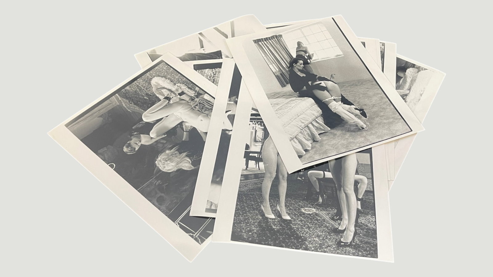 Vintage B&W Photography Collection – Pin-Up/Glamour Photographs c.1950s-1970s: A collection of black and white photographic prints depicting female glamour/pin-up subjects in various interior settings, consistent with mid-20th century photography conventions. The prints appear t