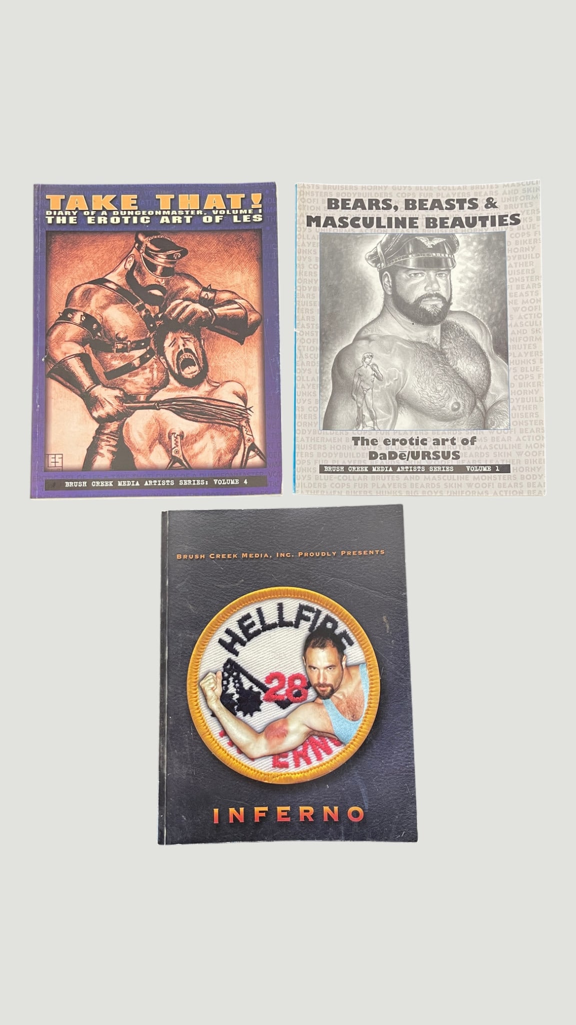 Brush Creek Media Adult Art Books x3: Take That!, Bears Beasts & Masculine Beauties, Inferno: A collection of three adult erotic art publications from Brush Creek Media, Inc., a prominent publisher of gay erotic content active in the 1990s-2000s. Included are 'Take That! The Erotic Art of Les'